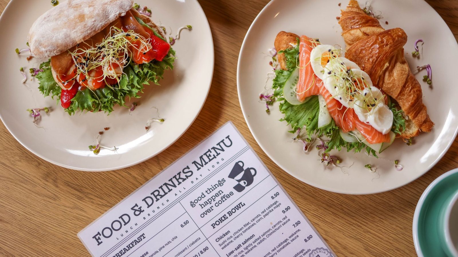Plated dishes beside a printed food and drinks menu