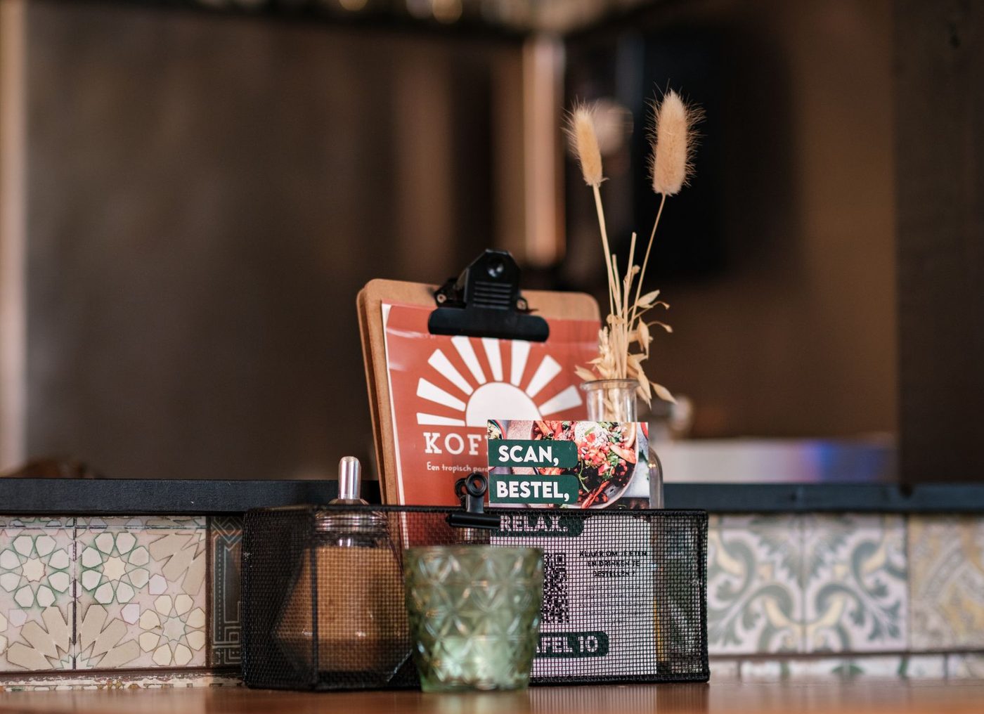 Restaurant table with a QR scan card and a printed menu beside it